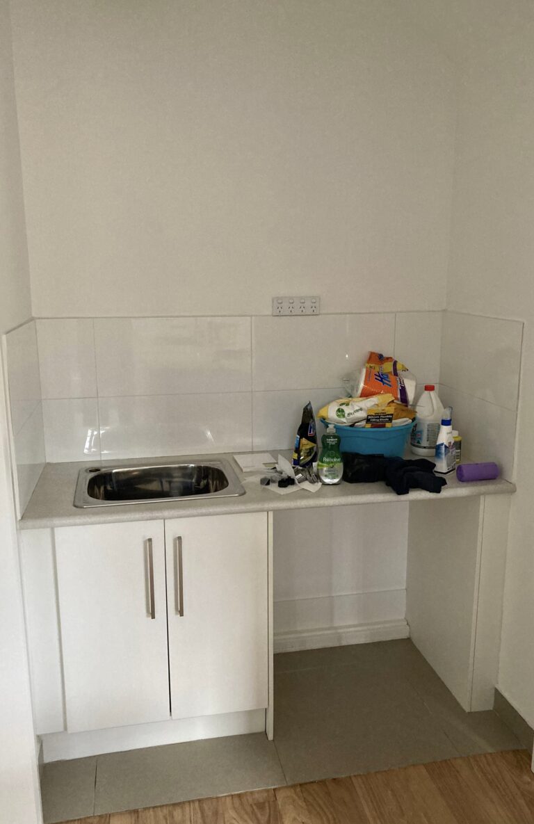 European style laundry renovation, sink with cupboards, white tiling and utility space
