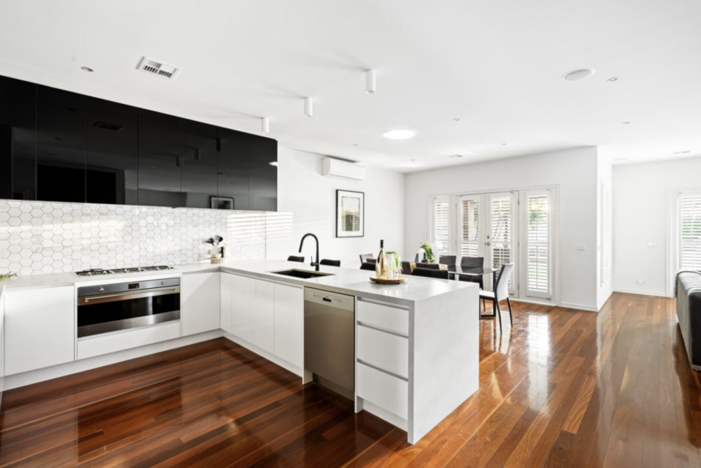 Black and white kitchen cabinetry with silver appliances in newly renovated family home Moonee Ponds, Melbourne