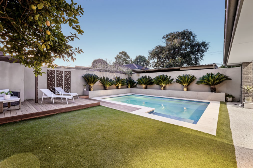 Backyard renovation with pergola decking, swimming pool and lawn in Melbourne